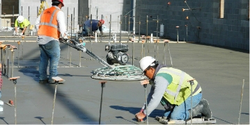Construction crew laying concrete